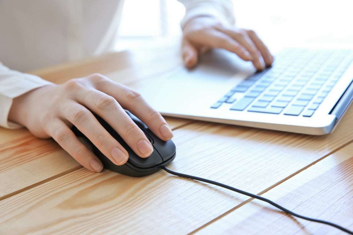 A Woman Using Wired Computer Mouse